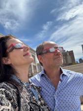 Gazing skyward as the solar eclipse begins, two guests atop on UWS penthouse. Photo: Heather Stein