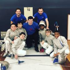 Tim Morehouse (center) with his fencing students and teaching staff.