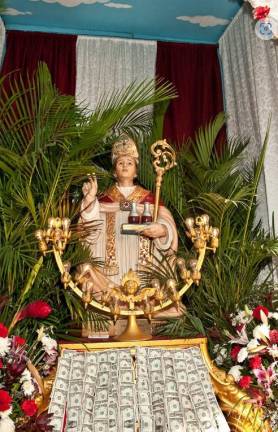 The statue of San Gennaro, the Italian saint that is celebrated with one of the oldest running street fairs in the United States each September, has been housed inside Most Precious Blood in recent years. Photo: Wikimedia Commons