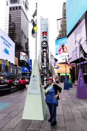 Karen Edka Makower next to her flag in Times Square. Photo: Maria Baranova