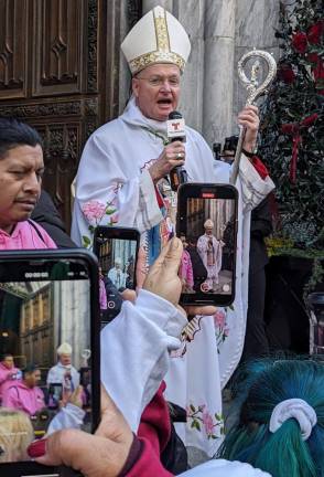 <b>Bishop Whalen, who is fluent in several languages, greets revelers in Spanish on the steps of St. Patrick’s Cathedral at the end of their two mile procession from Our Lady of Guadalupe at St. Bernard in the West Village.</b> Photo: Brian Berger