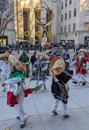Dancers in ceremonial masks outside Rockefeller Center celebrate the Feast of Our Lady of Guadalupe, the patron saint of Mexico and several other Latin American countries on Dec. 12. Photo: Brian Berger
