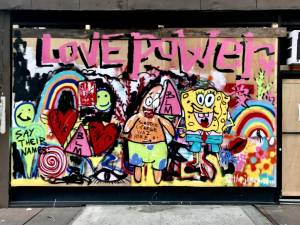 “Love Power” hanging in the storefront of Cote a Coast.