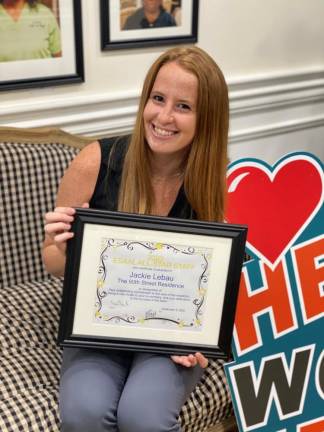 Activities Director Jackie LeBau of the 80th Street Residence with the 2020 All-Star Staff Award from the Empire State Association of Assisted Living. Photo courtesy of 80th Street Residence
