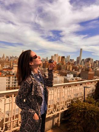 <b>Awaiting the solar eclipse while muching on a crispy creme donut atop a $16 million townhouse on the UES</b>. Photo: Heather Stein
