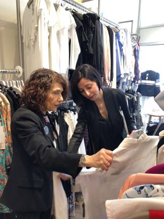Sales Associate Sharon Garfunkel (left) discussing an item of clothing with another sales associate at Fox's. Photo: Shoshy Ciment