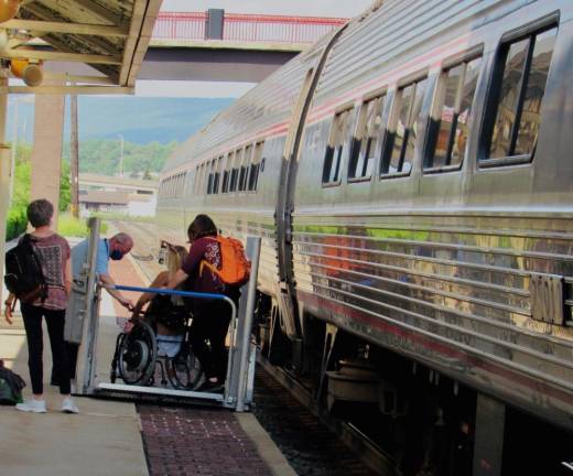 At the Amtrak Altoona PA stop, en route to Pittsburgh’s Union Station: a passenger, aided by an Amtrak staffer, uses a mobility lift to detrain. Inter-City buses and Amtrak are mandated by law to provide services for all passengers, regardless of their limitations, and can assist special-needs travelers with advance notification. Photo: Ralph Spielman