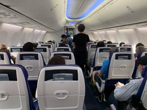 On this almost-full, spotless Southwest 737, the LED mood lighting and large overhead bins make for contented passengers en route from LaGuardia to Denver. Photo: Ralph Spielman
