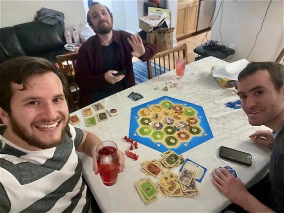 Playing “Settlers of Catan” (left to right): Gali, Matan and the author. Photo: Gali Gordon