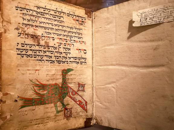 Opening to the prayer Shabbat Shekalim. This bright and beautiful manuscript page from a 14th century Mahzor was found in the binding of a later Christian theological text.