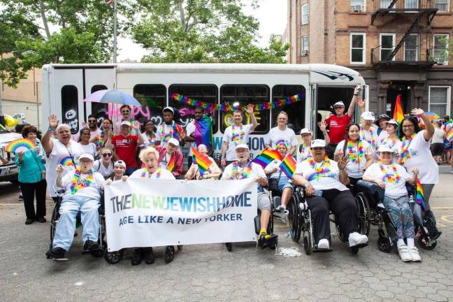 Residents, staff and volunteers of The New Jewish Home in front of their decorated bus before the 2018 Pride March. Photo: Tadej Znidarcic on behalf of The New Jewish Home.
