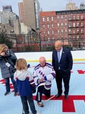 Rangers legend Brian Mullen signing autographs for a Junior Ranger–while Ed Gibbs looks over his shoulder–at the Feb. 1 ribbon-cutting for the renovated Paul L. McDermott Rink. It’s located inside the Stanley Isaacs Playground on E. 96th St. &amp; F.D.R Drive.
