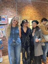 McKenna Camille (left) stands with fashion designer Kalita Hon (middle), and guest Ilona Ho (right) who came to see her show at the Neighbor Gallery in Chelsea on Feb. 11, featuring upcycled denim displays. The thrift store chic clothing industry is booming.