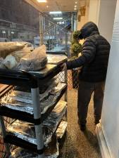 Dino Redzic, the operator of Uncle Paul’s Pizza, helped deliver 500 pizza pies to essential workers during the great NYC blizzard of 2026.