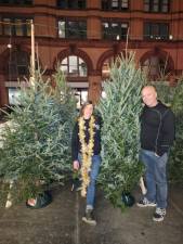 Heather Neville (with lights) says she places her Christmas tree orders in June. Her husband Dave, who is a roofer by trade, has time to assist her when bad weather slows down construction jobs in winter. Photo: Courtesy of Heather Neville