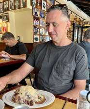 Here, Regen, from far-off New Zealand contemplates his Reuben sandwich ($31) before digging in. Alas the visitor from 9,000 miles away ate the top half, and dispatched the bottom away from the table.