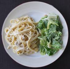 Protein builds and restores muscle mass, but it needs other ingredients to help it along. A meal of fettuccine alfredo with a side of Caesar salad could help, say some diet experts.