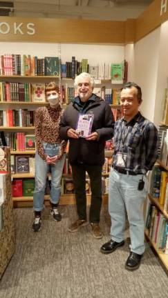 <b>The author (center) of the memoir “Bobby Ochs, Kid From the Bronx and Restaurant Partner to the Stars,” has worked with Patrick Swayze, Britney Spears and Marla Maples, poses with his just released paperback edition with Stella Williams (left) and Ken Tan, B&amp;N manager of the 87th St. and Third Ave. store. </b>Photo: Arlene Kayatt