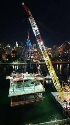 A crane unloads a prefabricated section of a research building addition at Rockefeller University over the FDR Drive last month. Photo: Courtesy of Councilman Ben Kallos
