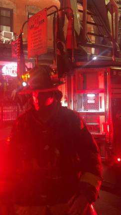 <b>A firefighter after extinguishing a blaze on the top floor of an East Village apartment on East 7th St. between First Ave. and Ave. A.</b> Photo: Keith J. Kelly