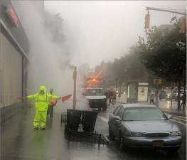 Sidewalk closed as water turned to steam below ground and the resutling steam blast forced a manhole cover to rotate ominously at E. 16th St. and First Ave. Photo: Keith J. Kelly