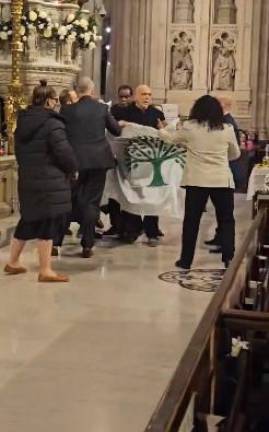 Protestors unveiled an olive tree banner reading “Silence=Death” at the Easter Vigil Mass at St. Patrick’s Cathedral on March 30. Photo: X (formerly Twitter)