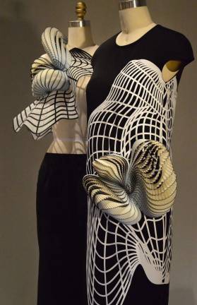 Gallery view of two Noa Raviv 2014 creations involving 3-D-printed polymer and hand-sewn tulle with adhesive appliqu&#xe9; of laser-cut polyester. Photo: Adel Gorgy