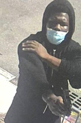 Faisil McCants and his gun on Madison Avenue in East Harlem, Aug. 27, 2025.