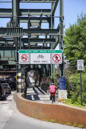 Signs on Queensboro Bridge warning against use of mopeds in bike lane on the Long Island City side.