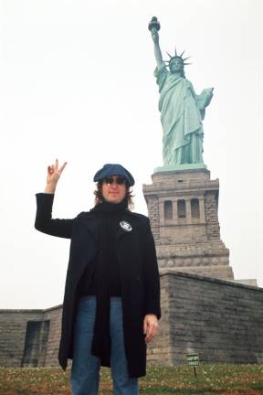 John Lennon and Statue of Liberty, 1974. Photo: Bob Gruen