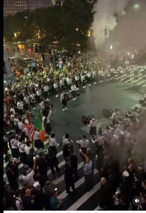 The FDNY Emerald Society Pipe and Drums near Ground Zero on 9-11, 2023 near House 10 on Liberty St, the closest to the Twin Towers on 9/11 which lost two members of ladder 10 and 3 from engine 10 and saw the firehouse itself destroyed. It was rebuilt thanks to a $1.45 million grant from FEMA to following year. Photo: FDNY