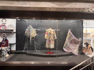 Works by Chin-Chih Yang are displayed behind the glass storefront of Whitebox Portable, a gallery located inside the Times Square subway complex.