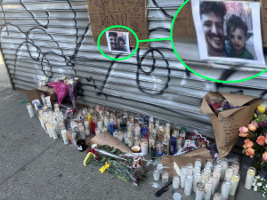 Candles, flowers and a handwritten sign at the makeshift memorial outside Sal’s Deli and Grocery were Abdul Saleh was killed on the night of April 25. The photo shows him with his young son.