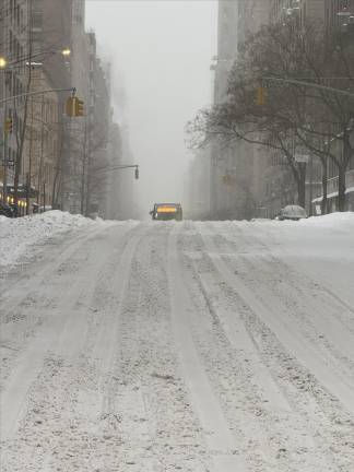 A bus makes its way over a hill on Madison Ave. Amazingly, buses and subways kept running with only a few temporary outages on the 7 and Q line running.