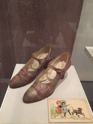 Unidentified maker. Mary Jane shoes, ca. 1926. Silk and metallic patterned fabric, embossed metal buttons. Stuart Weitzman Collection. Photo:  Val CastronovoRichard F. Outcault (1863-1928). Postcard, 1906. Color lithograph. New-York Historical Society. Photo:  Val Castronovo