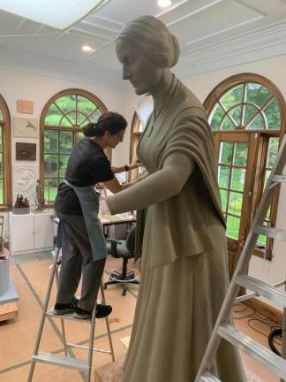 Sculptor Meredith Bergmann at work on the statue in her studio.