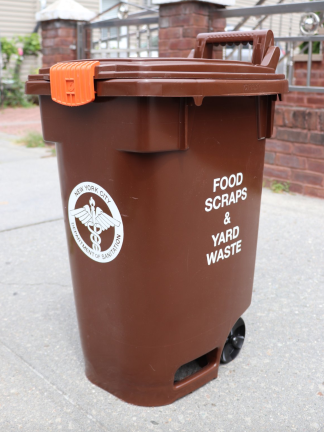 The special brown compost bin where residents are now required to place their food scraps and lawn clippings. Mandatory fines for failing to separate food waste from other trash kick in as of April 1.