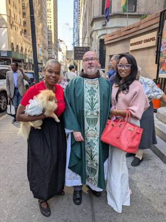 A day late, two women from Staten Island still got their Pomeranian blessed by Father James Bernard of the Church of St. Francis of Assisi on West 31st Street.
