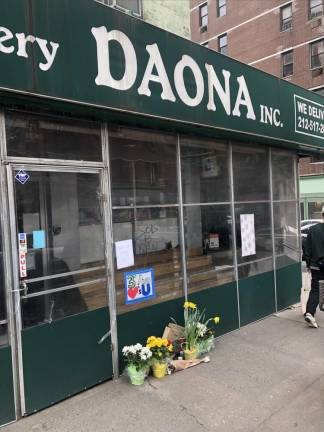 <b>A small memorial was forming outside Daona Deli &amp; Grocery on Sunday morning on E. 81st and Third Ave. as news spread that a beloved deli worker on the late night shift had been killed by a gunman dressed in a Haz Mat suit. </b>Photo: Keith J. Kelly