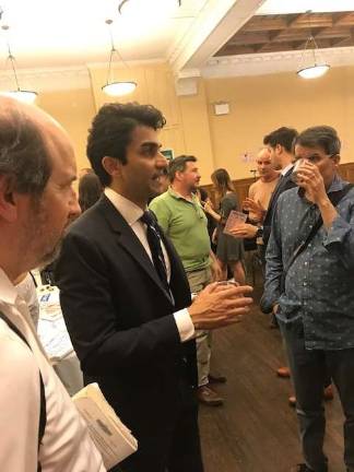 Suraj Patel, who is trying to unseat Congresswoman Carolyn Maloney in a Democratic primary challenge on the East Side, mingles with voters over wine and cheese at a town hall meeting in the Church of the Holy Trinity on East 88th Street last Thursday. Photo: Douglas Feiden