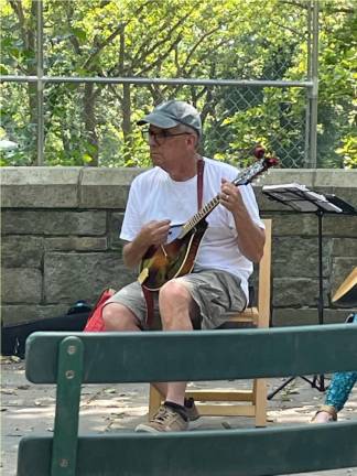 Ronald Zwerdling, seated, plays with the jam he helps organize in Riverside Park. Photo: Christopher Moore