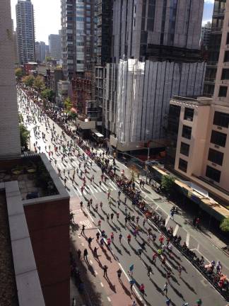 The New York City Marathon field running up First Avenue in Yorkville shortly after 1 p.m. Sunday. More than 50,000 people from 120 countries participated. Photo: Rick Sayers