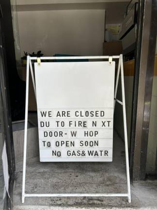 Sign outside Jugos writing ‘We are closed du (sic) to fire next door - W hop (sic) to open soon - No gas &amp; watr (sic).”