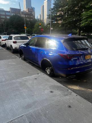 A car left on milk crates near 64th and Riverside after a reported wheel theft, one of several incidents recently shared on local forums.