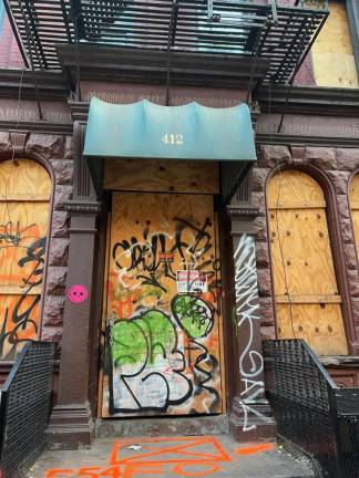 The exterior of 412 W. 46th St., now boarded up due to a fire, is just one address that drew the city’s ire against notorious landlord Daniel Ohebshalom.