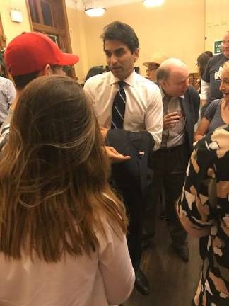 Suraj Patel, who is trying to unseat Congresswoman Carolyn Maloney in a Democratic primary challenge on the East Side, mingles with voters over wine and cheese at a town hall meeting in the Church of the Holy Trinity on East 88th Street last Thursday. Photo: Douglas Feiden