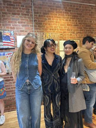 Camille (left) stands with fashion designer Kalita hon (middle), and guest Ilona Ho (right) who came to see her show at the Neighbor Gallery in Chelsea on Feb. 11