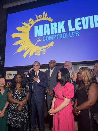 Surrounded by friends, family, and endorsers, Mark Levine speaks at his election-night watch party on June 24.