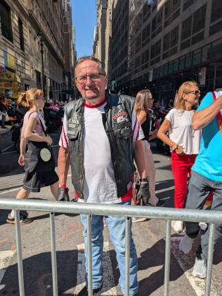 A Polish motorcyclist in his Husaria motorcycle club vest.