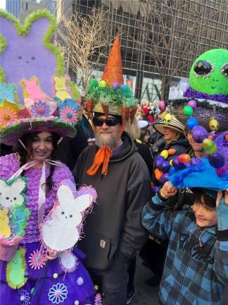 Kerry Tobin (left) said she started constructing the elaborate hats for her husband John (next to her) and her two sons about two weeks ago for this year’s Easter Parade. Photo: Keith J. Kelly